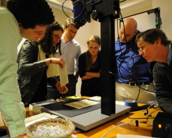 Renate Mesmer (second from left), head of conservation at the Folger Shakespeare Library, repositions the 'Archaionomia' under the imaging camera as (left to right) Mitchell Hobbs, Gregory Heyworth, Kristen Vise and Andrew Henning, all of the University of Mississippi, and William A. Christens-Barry, chief scientist with Equipoise Imaging, watch. UM photo by Robert Jordan.