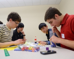 Oxford High students Connor Goggans, Mark Zhao, Joonhee Jo and Brian Clancy (l-r) participate in the team activity portion of the 2013 Engineering Day Competition.  Photo by Nathan Latil/Ole Miss Communications