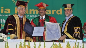 Hamdrad University Chancellor Saiyid Hamid (left) and Registrar Firdous Wani (right) present an honorary degree to Ikhlas A. Khan during ceremonies in India.