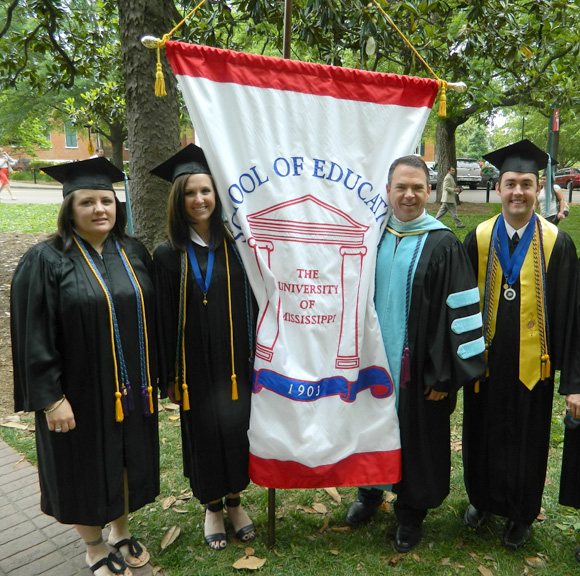 Education Taylor Medalists and Dean David Rock during the May 12, 2012 School of Education graduation ceremony. (left to right) Kerry Franks, Carroll Lee, Rock and Matthew Craig Pharr. 