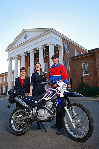 UM Vice Chancellor for Student Affairs Brandi Hephner LaBanc (left), Director of Parent Development Elizabeth Milhous and University Police Officer Daniel Ross get a look at a new motorcycle donated to UPD by the Parents Council. UM photo by Robert Jordan.