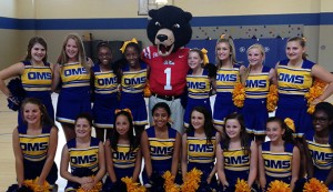 Members of the Oxford Middle School cheerleading squad pose with Rebel.