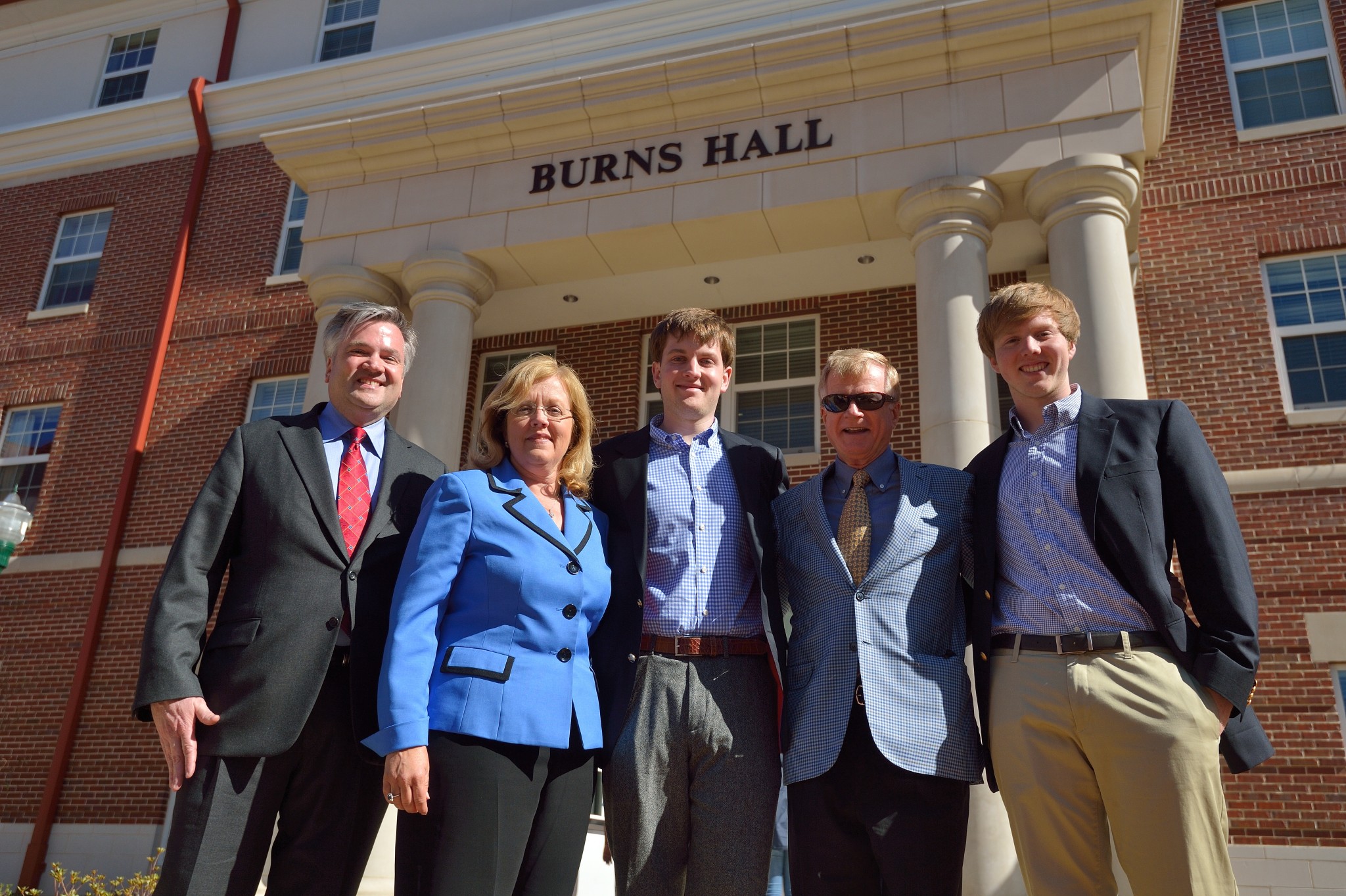 Roland Burns with wife, Sheryl, son Derek, Ole Miss Accountancy Professor Jimmy Davis and son Tyler stand in front of the newly dedicated Burns Hall. Roland and Derek shared Davis as a professor while at Ole Miss, and youngest son, Tyler will be taking a class Davis is teaching this fall. 