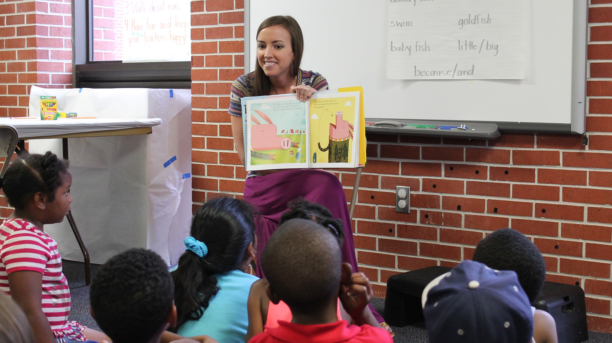 CELI literacy specialist Olivia Morgan reads Pig and Small to children at Willie Price Lab School at UM. 