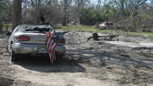 A Hurricane Katrina damaged car sits beside the slab of a south Mississippi home that was washed away by the Aug. 29, 2005 storm. Photo by Michael Newsom. 