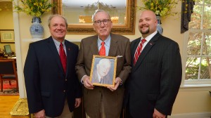 Longtime UM donor John Glass, center, holds a photo of his father, the late William Quintard Glass. John Glass is paying tribute to his father’s influence with a named faculty chair in the Meek School of Journalism and New Media. On hand to thank Glass for his support are UM Foundation President/CEO Wendell Weakley, left, and School of Business Administration Development Officer Adam Lee. Part of Glass’ gift also will benefit the business school. Photo by Thomas Graning/Ole Miss Communications