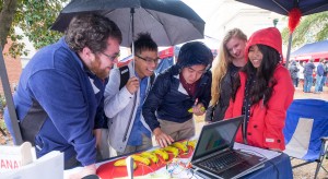 Engineering Librarian Bryan Young shows students how to use the banana piano in the Grove.