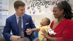 Eli Manning (left) chats with Batson Children's Hospital patient Davionna Arrington and mom Roshanna during a visit to the hospital by the Ole Miss alumnus and NFL quarterback.