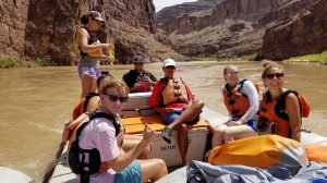 Ben Bradford (left) and Anna Daniels (behind) relax with their tour guides and fellow students Eveanne Eason (second from right) and Sally Boswell as they float down the Colorado River during their visit to the Grand Canyon as part of their introductory excursion as Stamps scholars at the University of Mississippi. Photo courtesy James Asbill