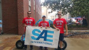 UM chapter of the Society of Automotive Engineers members display their flag on campus. (Submitted photo)