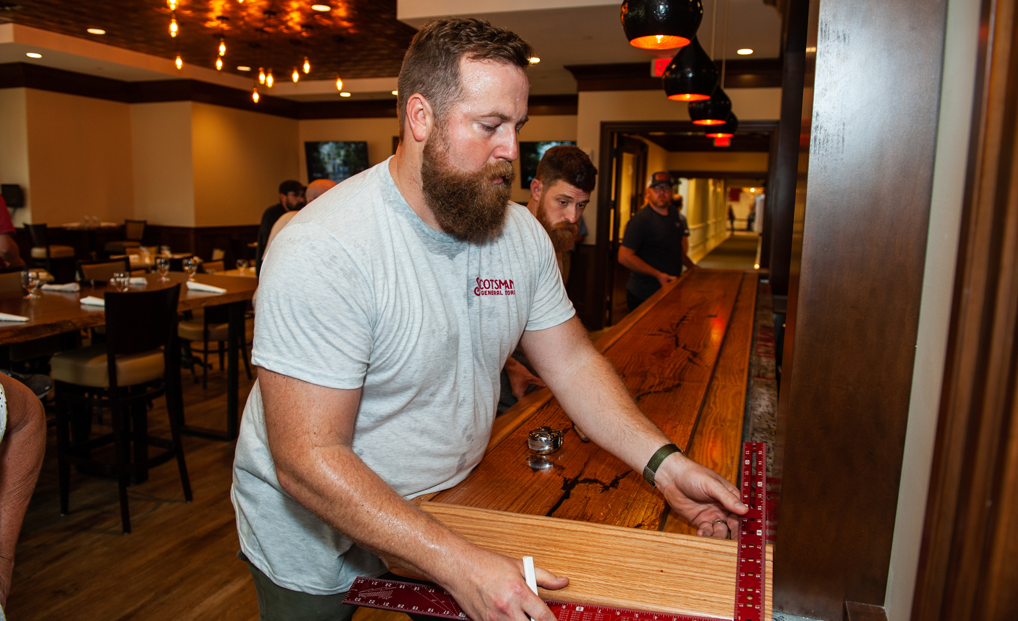 UM alumnus Ben Napier helps install a bar top he created at McCormick’s, the new full-service restaurant and bar at The Inn at Ole Miss. Photo by Bill Dabney/UM Foundation