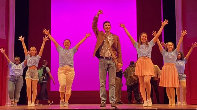 Students sing and dance during rehearsal of a scene from Legally Blonde the Musical
