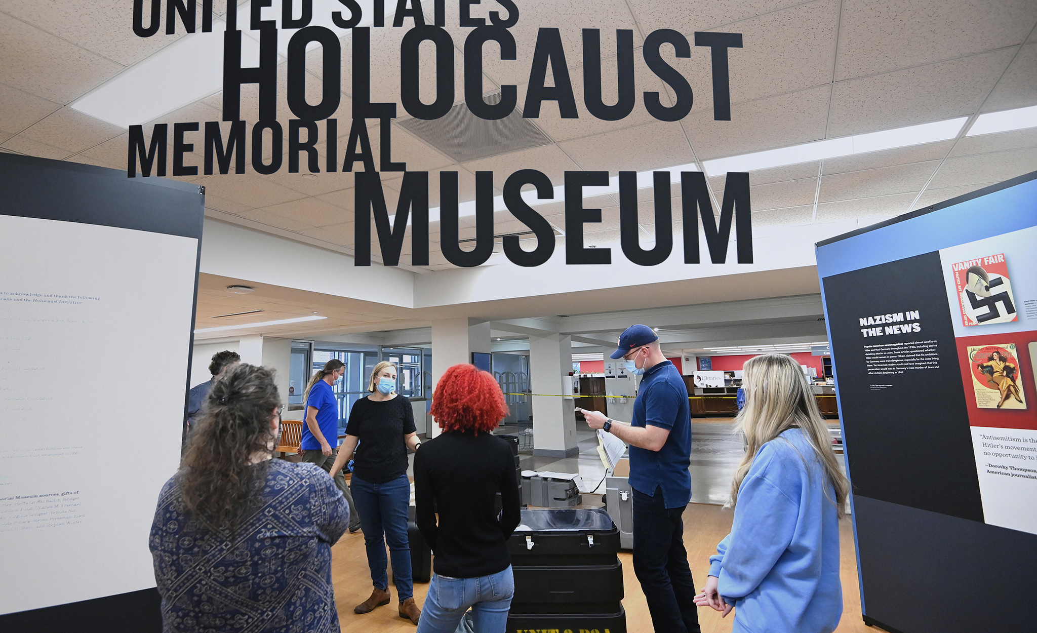 UM library staff members install the United States Holocaust Memorial Museum exhibit in the J.D. Williams Library. The display is open through HJan. 14.