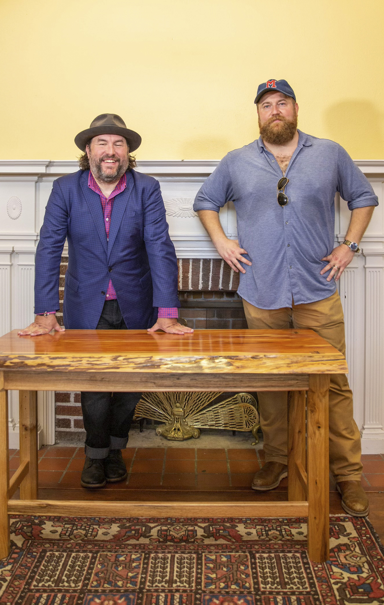Wright Thompson and Ben Napier stand behind the wooden desk made by Napier
