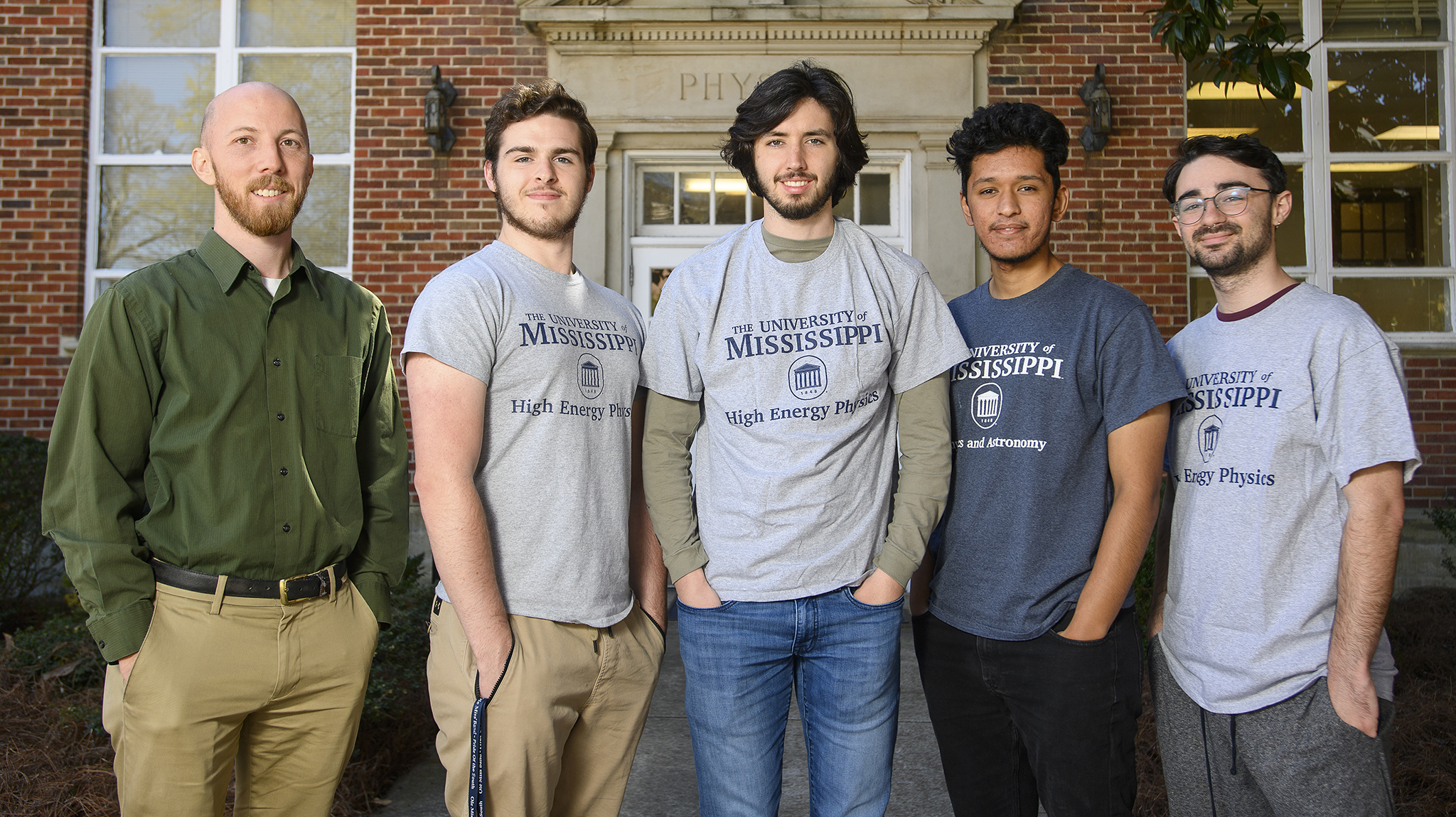Jake BEnnett stands with a team of undergraduate researchers