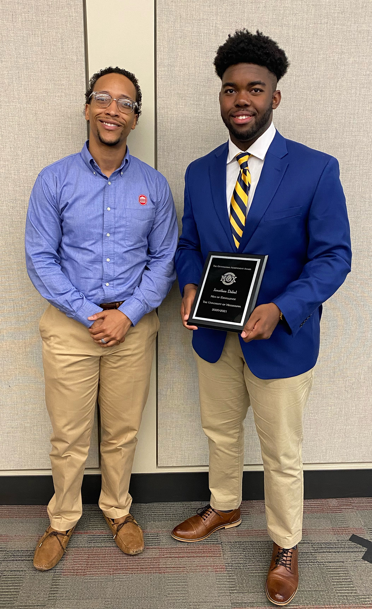 EJ Edney (left), UM assistant vice chancellor of diversity and inclusion, congratulates Jonathan Dabel for receiving an award from the Men of Excellence organization. Edney has served as a mentor for Dabel during his time on campus. Submitted photo