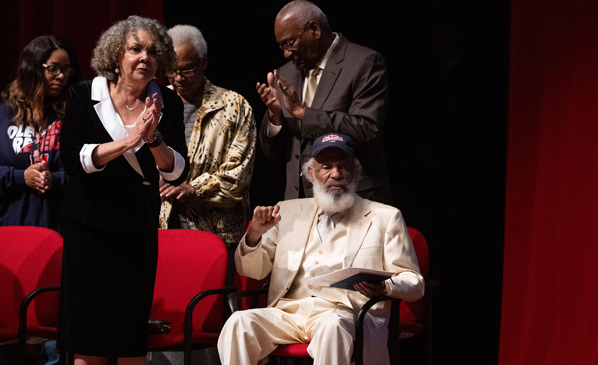 James Meredith (seated) is applauded by the crowd at the Ford Center, including his wife, Judy (left) during ‘The Mission Continues: Building Upon the Legacy.’ Photo by Thomas Graning/Ole Miss Digital Imaging Services