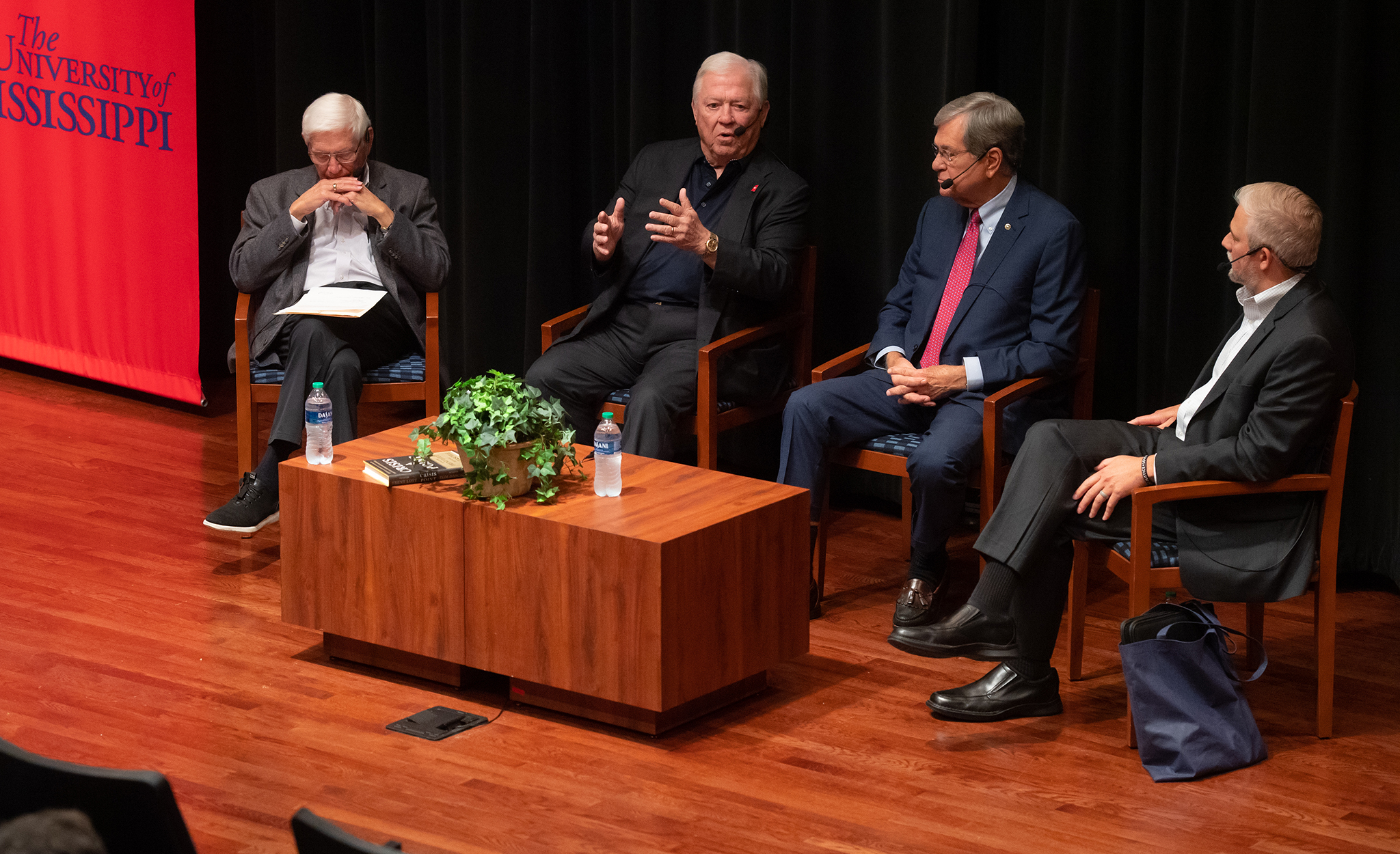 Former Gov. Haley Barbour (second from left) and retired U.S. Sen. Trent Lott (third from left) discuss the importance of bipartisan cooperation to solve problems during the ‘Moving Mississippi Forward’ public discussion at Ole Miss. Co-sponsored by the university’s Lott Leadership Institute and Barbour Center for Manufacturing Excellence, the event also featured moderators Bill Gotshall (left), Lott Institute executive director, and Scott Kilpatrick, CME director. Photo by Kevin Bain/Ole Miss Digital Imaging Services