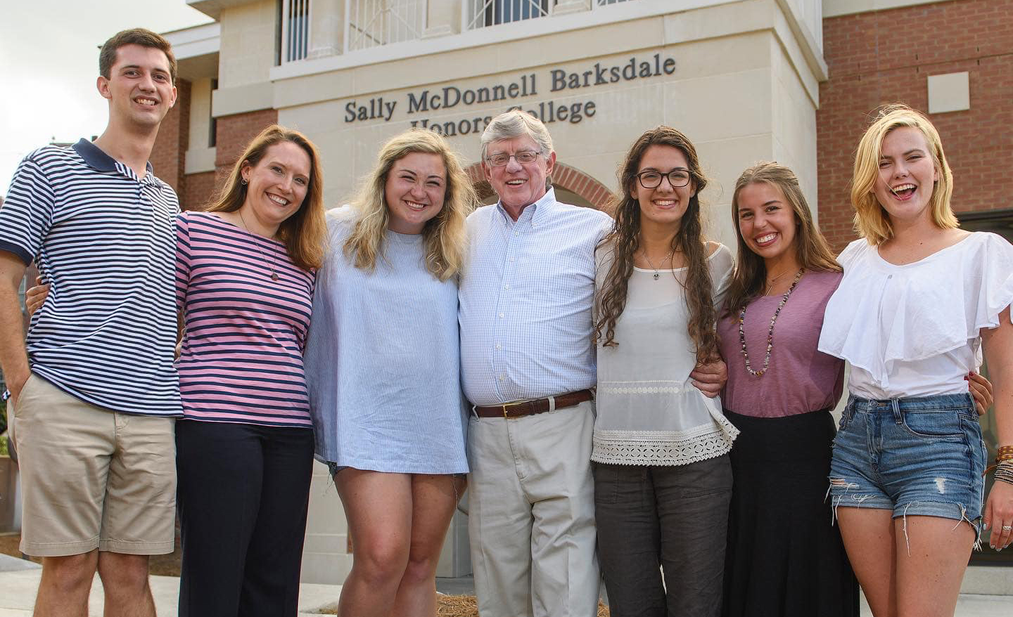 John Winkle (center) hangs out with several of his students in the Sally McDonnell Barksdale Honors College. Winkle’s students across campus are remembering how the late professor of political science both challenged and encouraged them. Photo by Thomas Graning/Ole Miss Digital Imaging Services