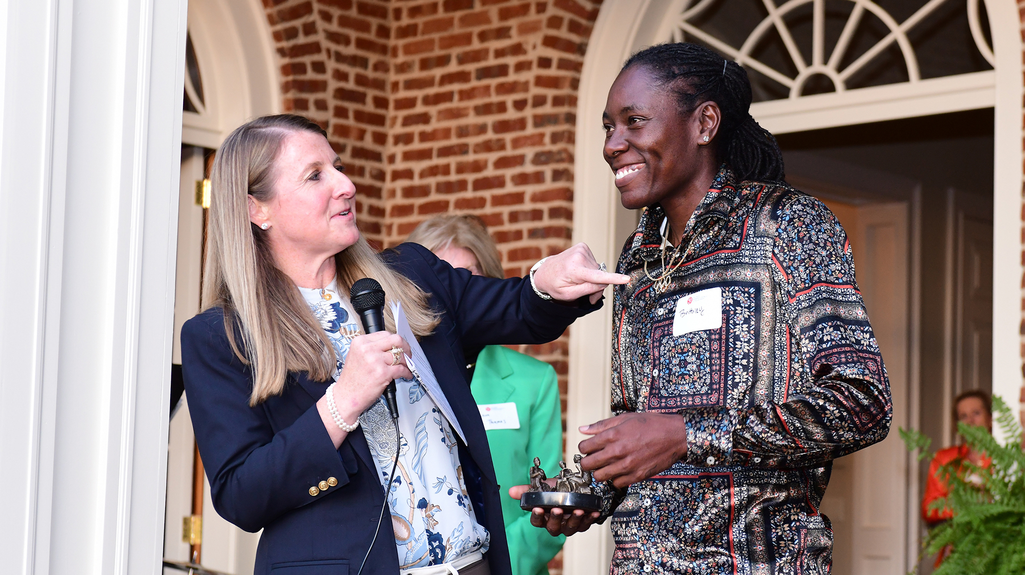 Elizabeth Randall (left), immediate past chair of the Ole Miss Women’s Council for Philanthropy, presents the council’s Emerging Young Philanthropist Award to Brittney Reese, UM alumna and celebrated Olympic long jumper. Photo by Joey Brent