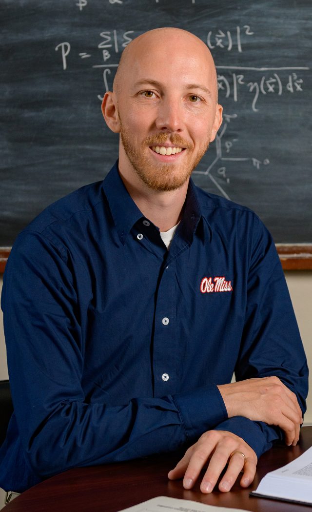 Physicist Jake Bennett is part of an international team studying the tiniest particles of matter in hopes of broadening our understanding of the nature of all matter in the universe. Photo by Robert Jordan/Ole Miss Digital Imaging Services