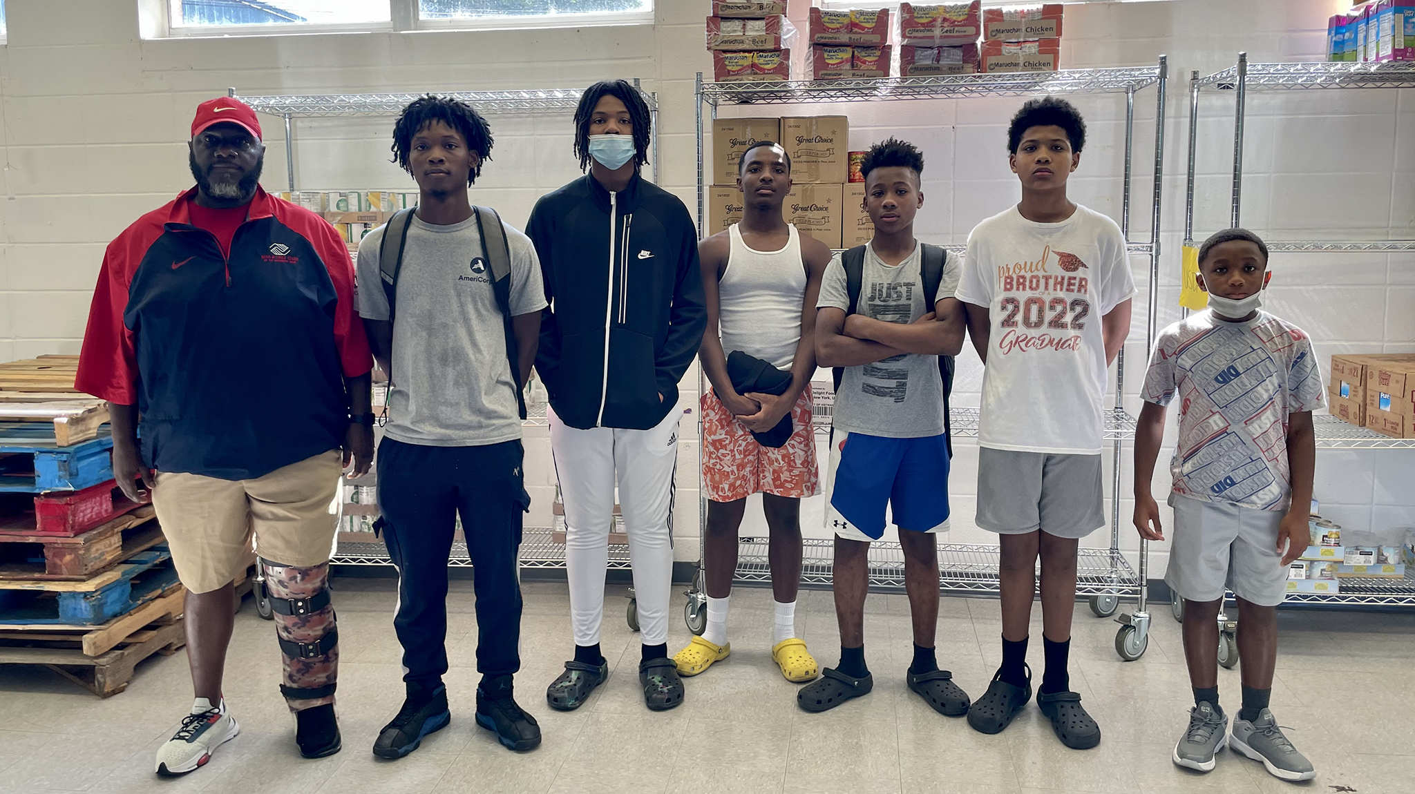 VISTA member Jamarcus Brown (second from left) engages youth from the Boys of Girls Club of Lexington in food distribution efforts at the Lexington Food Pantry. Submitted photo