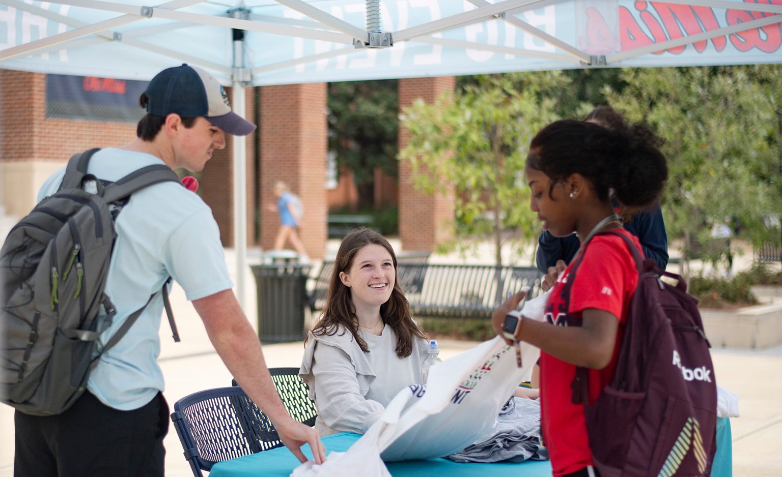 Students browse information about the Big Event at a sign-up table on the Ole Miss Student Union Plaza. Photo by Logan Kirkland/Ole Miss Digital Imaging Services