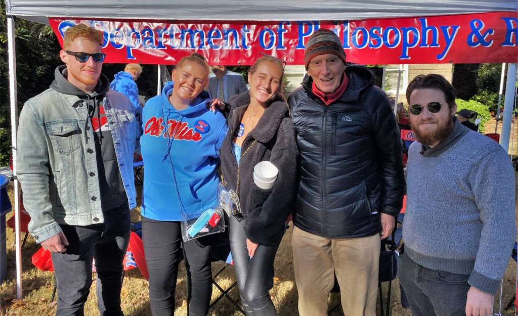 Cliff McKay (second from right) visits with classmates at a Department of Philosophy and Religion tailgate in the Grove in fall 2019. McKay, who was a chaplain at the university from 1959 to 1964, says he is pleased how it has grown and diversified in the years since its integration. Submitted photo