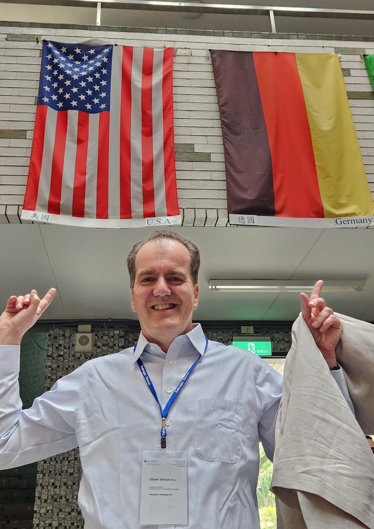 Oliver Dinius, executive director of the Croft Institute for International Studies, poses with American and German flags at the Fu Jen International Student Office at Fu Jen Catholic University in Taiwan. Dinius, who grew up in Germany, used his 2020-21 Fulbright IEA award to visit universities that could become study abroad locations for Ole Miss students. Submitted photo