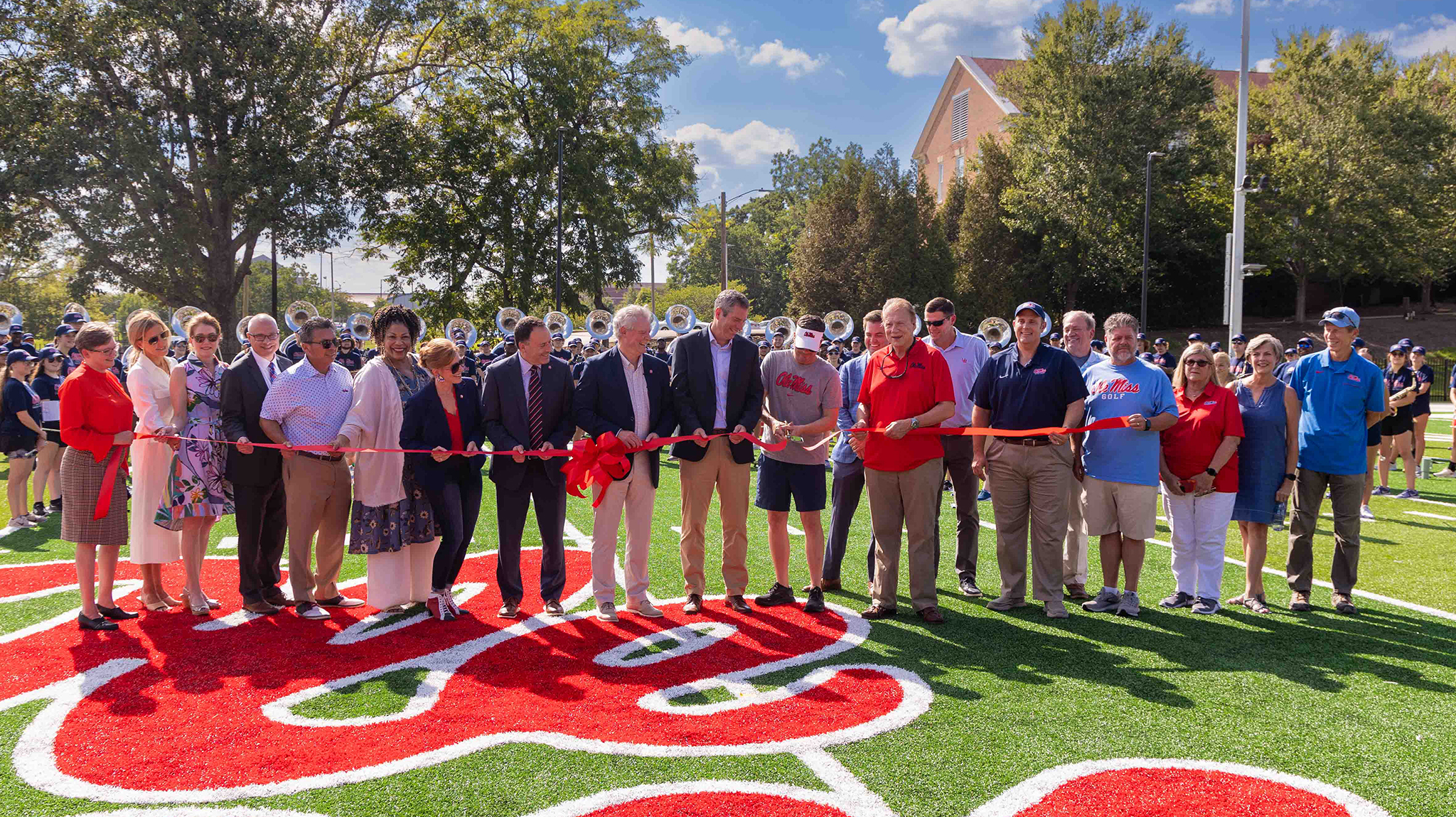 University leaders watch as Randy Dale (center), associate director of bands and director of athletic bands, center, cuts the ribbon on the new $5.4 million practice facility for the Pride of the South marching band. Photo by Amy Howell/University Development