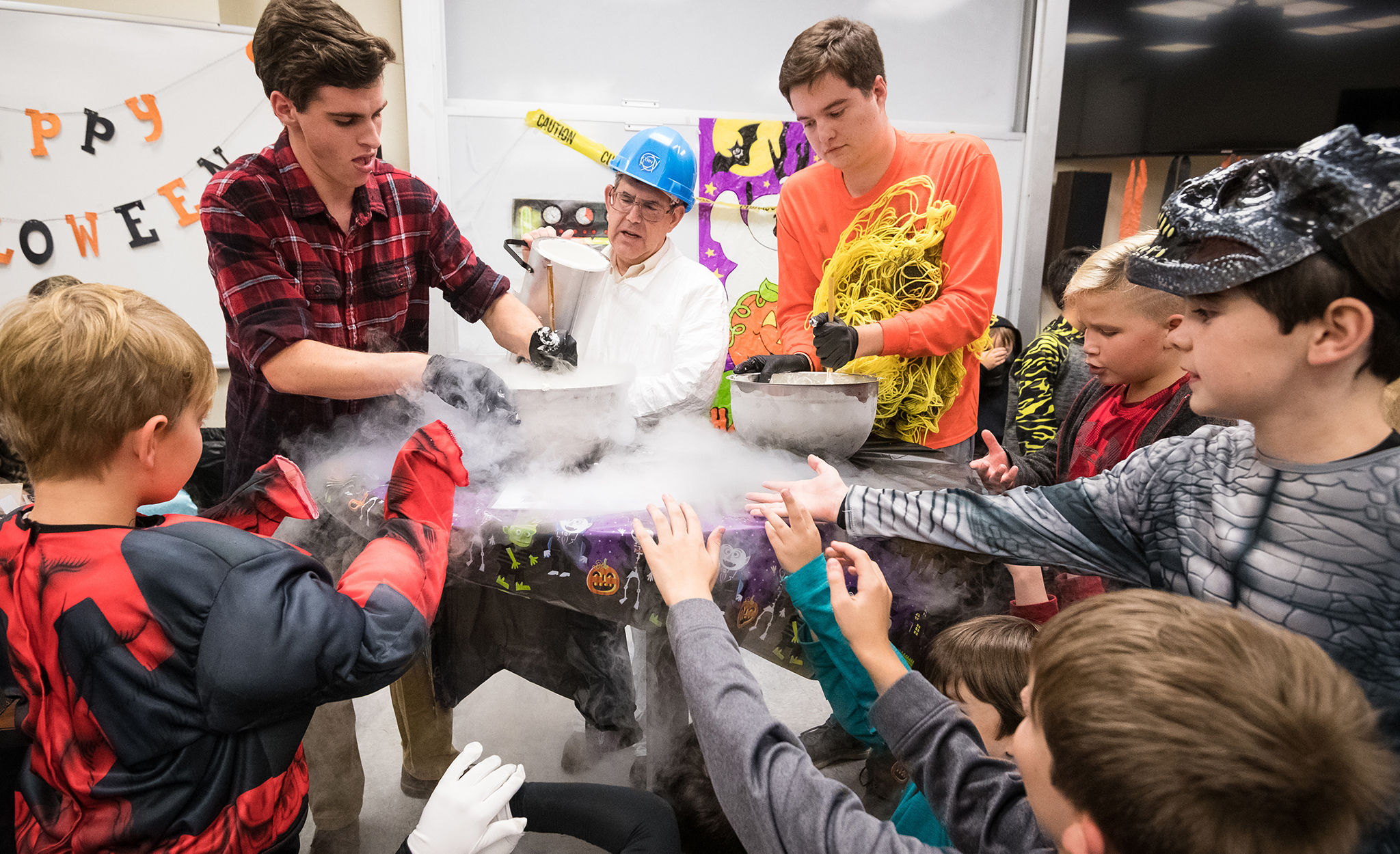 physics graduate students help prepare ice cream using liquid nitrogen as costumed customers await during Spooky Physics Night, hosted by the Department of Physics and Astronomy. Photo by Megan Wolfe/Ole Miss Digital Imaging Services