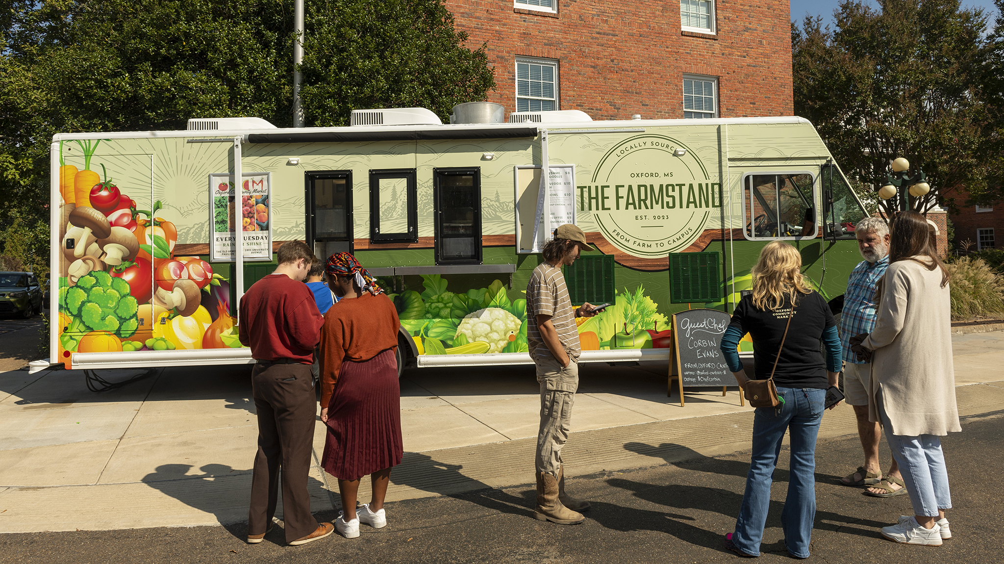 Students and staff members line up as The Farmstand food truck opens for business on campus. The venue is the result of a collaboration between the university’s Office of Sustainability, Grisham-McLean Institute and Department of Nutrition and Hospitality Management, and the Oxford Community Market. Photo by Srijita Chattopadhyay/Ole Miss Digital Imaging Services
