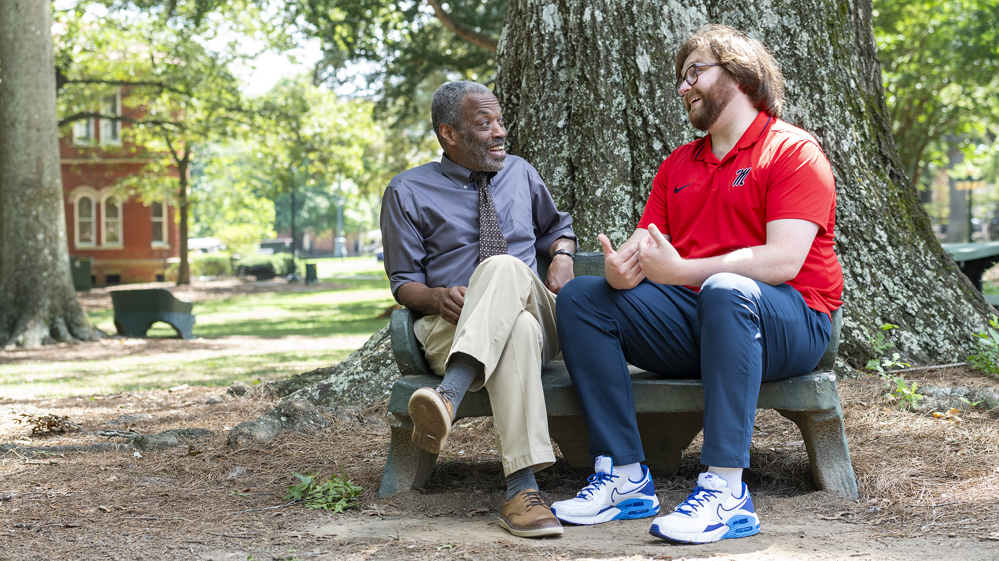Kirk Johnson (left), associate professor of sociology and African American studies, and Randy Morgan, learning specialist for Student Academic Services, reconnect in the Grove. Johnson first inspired Morgan to study sociology, which has become one of his passions, and later persuaded him to complete his master’s degree. Photo by Srijita Chattopadhyay/Ole Miss Digital Imaging Services